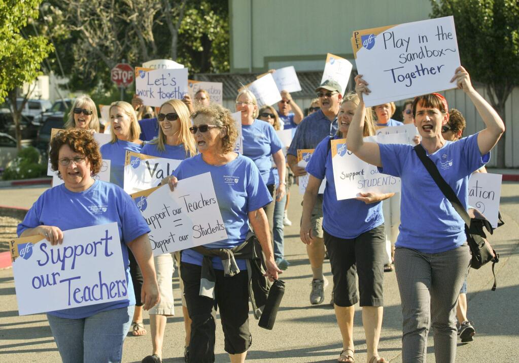 Petaluma City Schools teachers march to the Petaluma City Schools school board meeting in Petaluma on Tuesday night August 19, 2014, to draw attention to the fact that they have no contract and among other things haven't had a cost of living raise in seven years. (SCOTT MANCHESTER/ARGUS-COURIER STAFF)