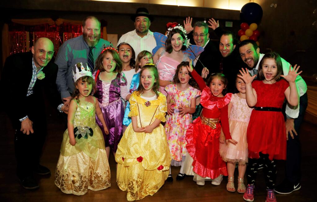 A group of chaperones and kids posed for a photo at the Fairy Tale Ball which featured a visit from Princess Belle, dancing, craft projects and a photo booth at the Finley Community Center, Saturday February 24, 2018. (Photo: Will Bucquoy for the Press Democrat)
