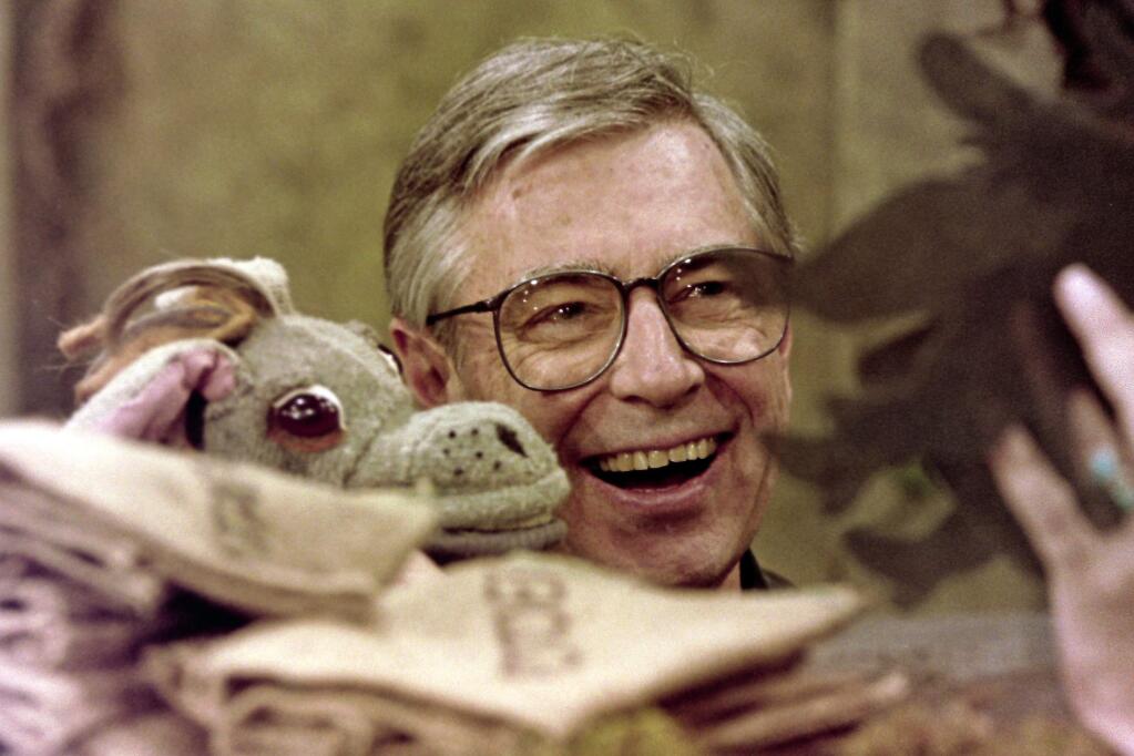 Fred Rogers worksg with Donkey Hodie, one of the puppets featured on his children's television program, 'Mr. Rogers' Neighborhood.' (GENE J. PUSKAR / Associated Press, 1993)
