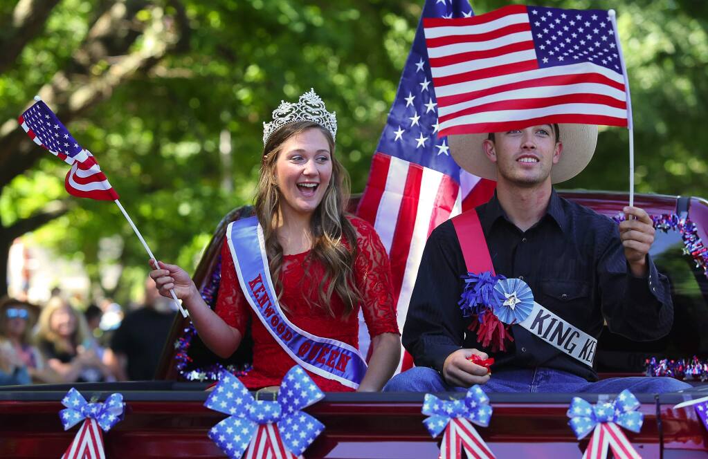 The queen and king of the Kenwood 4th of July Hometown Parade, Allie Ahern, left, and Dominic Amantite, wave to the crowd, in Kenwood, in 2016. (Christopher Chung/ The Press Democrat)