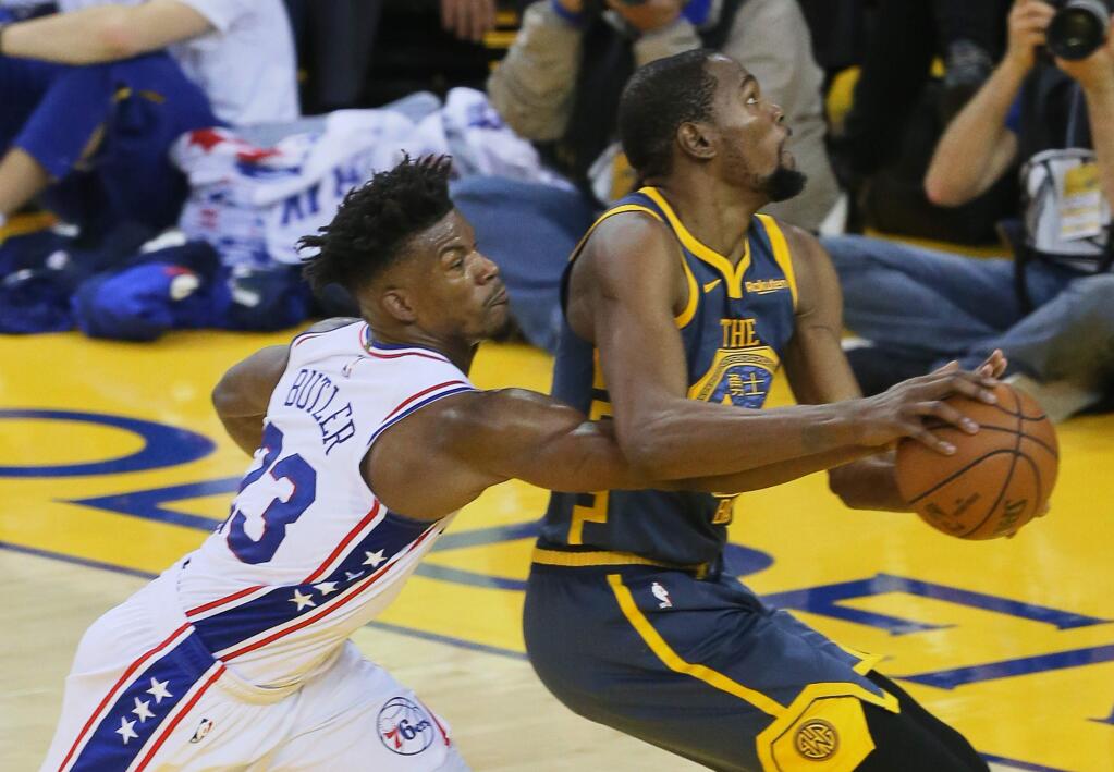 Warriors forward Kevin Durant has the ball stripped away by 76ers forward Jimmy Butler, during their game in Oakland on Thursday, January 31, 2019. (Christopher Chung/ The Press Democrat)