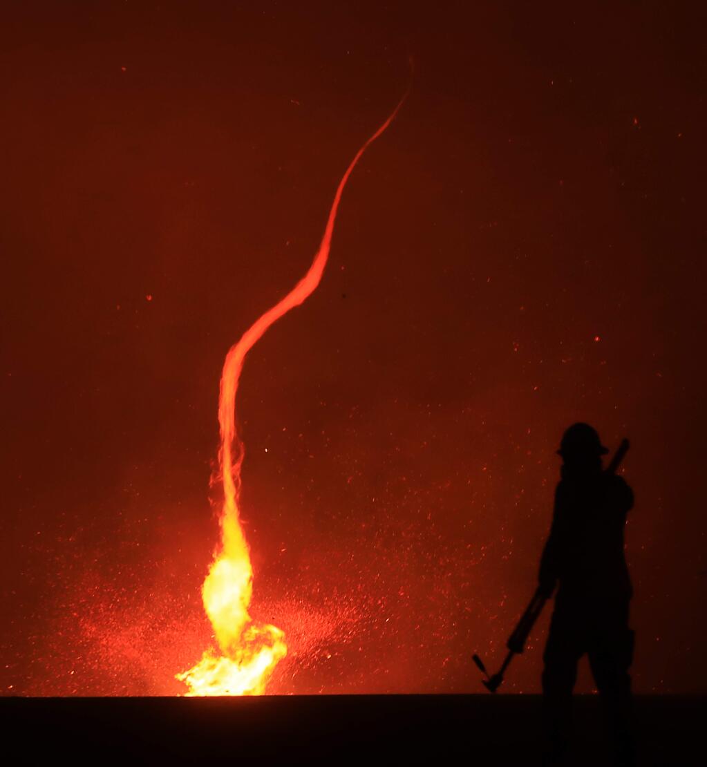 A fire whirl whips across dry brush during the Kincade fire in The Geysers region of Sonoma County on Thursday, Oct, 24, 2019. (KENT PORTER/ PD)