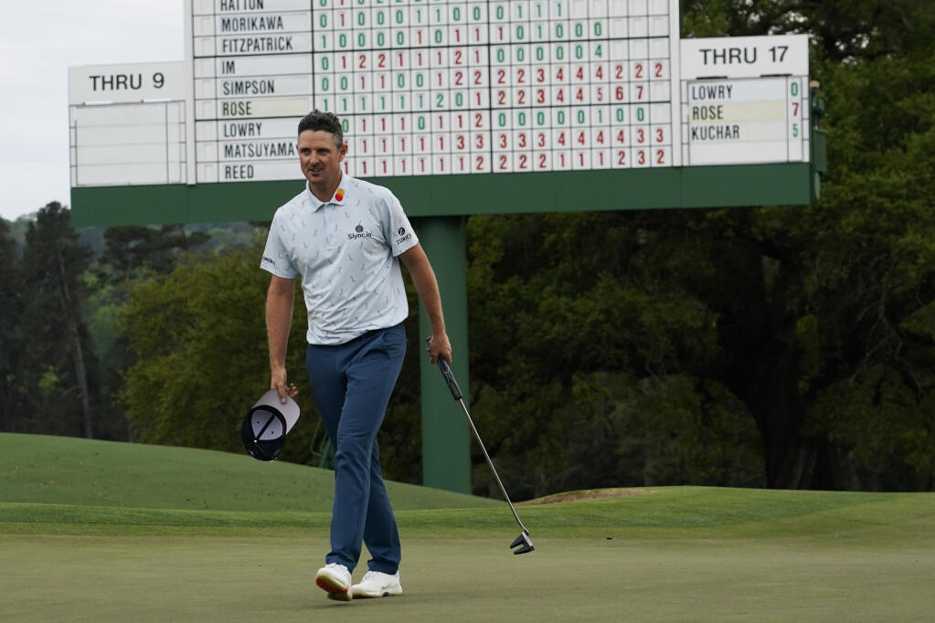 Justin Rose walks off the 18th hole with a seven-under par first round at the Masters on Thursday, April 8, 2021, in Augusta, Georgia. (David J. Phillip / ASSOCIATED PRESS)
