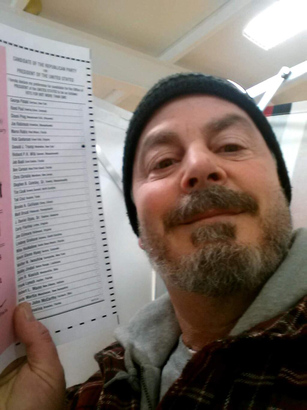 In this Feb. 9, 2016, photo, provided by Bill Phillips, of Nashua, N.H., Phillips takes a selfie with his marked election ballot. The secrecy of the voting booth may soon be a thing of the past. Ballot selfies, where people use smartphones to photograph and share their marked ballots online, are becoming more common, as voters young and old look to share their views with family, friends and the world. But what they don't realize is they may be breaking the law, depending on where they live. (Bill Phillips via AP)