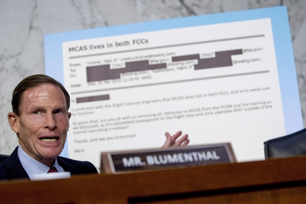 Rep. Richard Blumenthal, D-Conn., displays an email exchange behind him as he questions Boeing Company President and Chief Executive Officer Dennis Muilenburg as he testifies before a Senate Committee on Commerce, Science, and Transportation hearing on 'Aviation Safety and the Future of Boeing's 737 MAX' on Capitol Hill in Washington, Tuesday, Oct. 29, 2019. (AP Photo/Andrew Harnik)