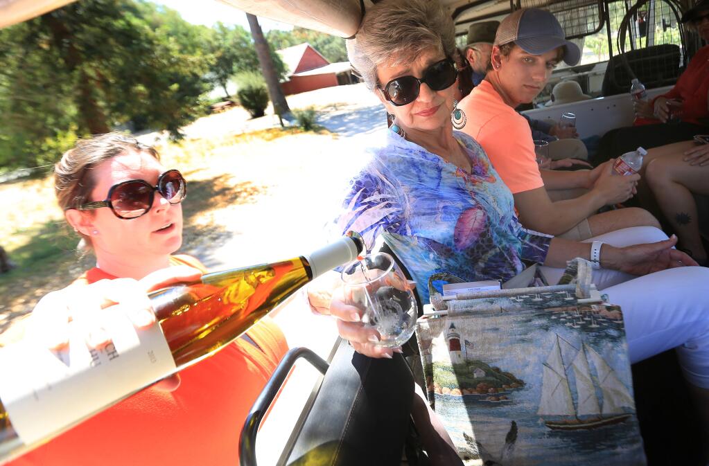 Tour guide Maggie Waller pours Little Rock resident Ruth Rorie a glass of wine during the Gundlach Bundschu Winery and Vineyards Pinzgauer vineyard tour, Monday June 8, 2015 in Sonoma. (Kent Porter / Press Democrat) 2015