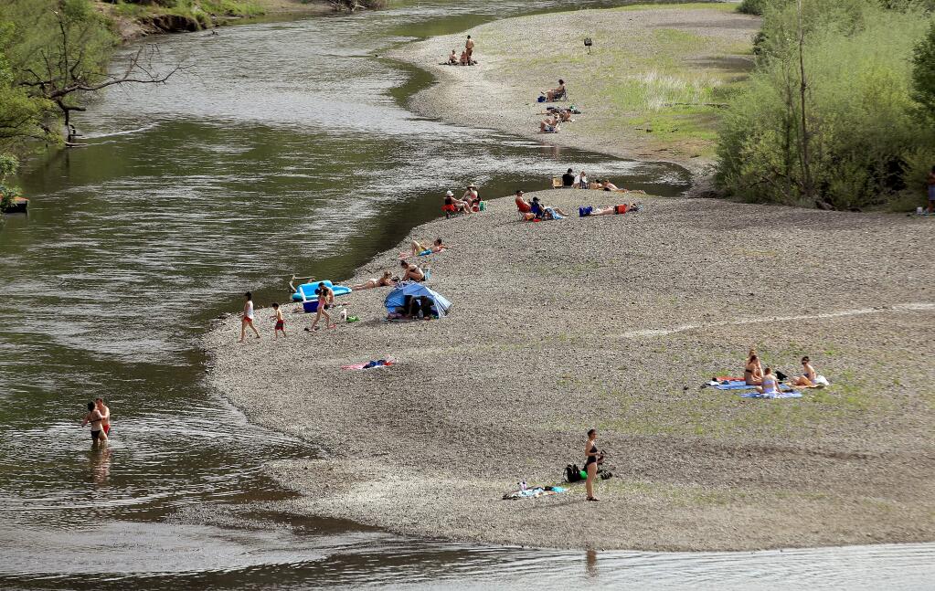 Warm weather prompted some county residents to visit the Russian River in the Sunset Beach area of Forestville, Saturday, April 25, 2020. (Kent Porter / The Press Democrat) 2020