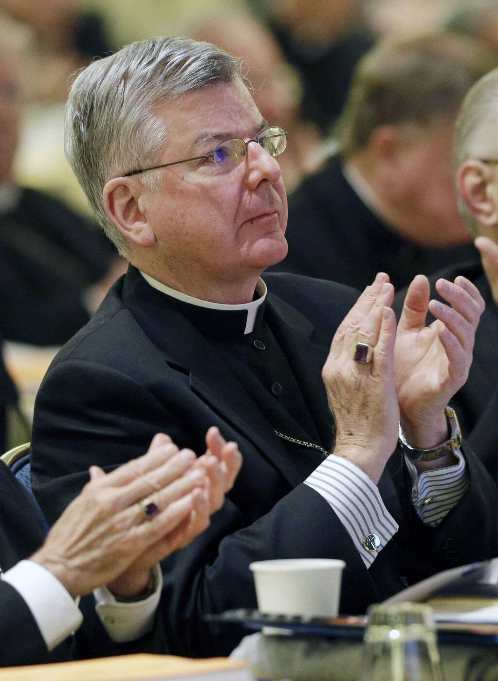 FILE - In this Nov. 12, 2013 file photo, Archbishop John Nienstedt, of St. Paul and Minneapolis, applauds after a presentation at the United States Conference of Catholic Bishops' annual fall meeting in Baltimore. Jennifer Haselberger, the whistleblower who took on the Archdiocese of St. Paul and Minneapolis about allegations of clergy sexual misconduct, said in an affidavit released Tuesday, July 15, 2014, that archbishops and staff ignored the 2002 pledge by Roman Catholic bishops to keep abusive clergy out of parishes. (AP Photo/Patrick Semansky, File)
