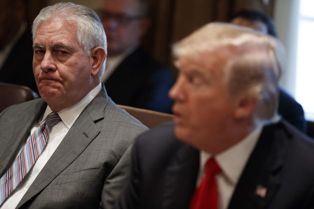 Secretary of State Rex Tillerson, left, listens to President Donald Trump speak during a cabinet meeting at the White House, Wednesday, Jan. 10, 2018, in Washington. (AP Photo/Evan Vucci)
