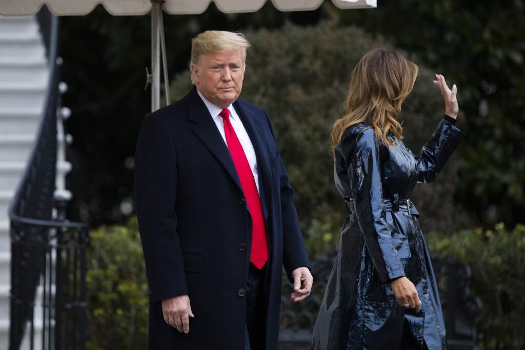 President Donald Trump and first lady Melania Trump walk from he Diplomatic Room as they leave the White House, Monday, Jan. 13, 2020, in Washington, for a trip to watch the College Football Playoff national championship game between LSU and Clemson in New Orleans. (AP Photo/Manuel Balce Ceneta)