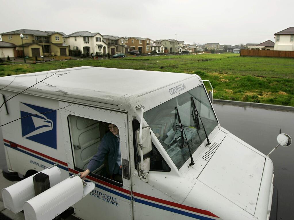Lisa Emond delivers mail next to a Ryder Homes subdivision in southwest Santa Rosa in this March 2010 file photo. (KENT PORTER/THE PRESS DEMOCRAT)
