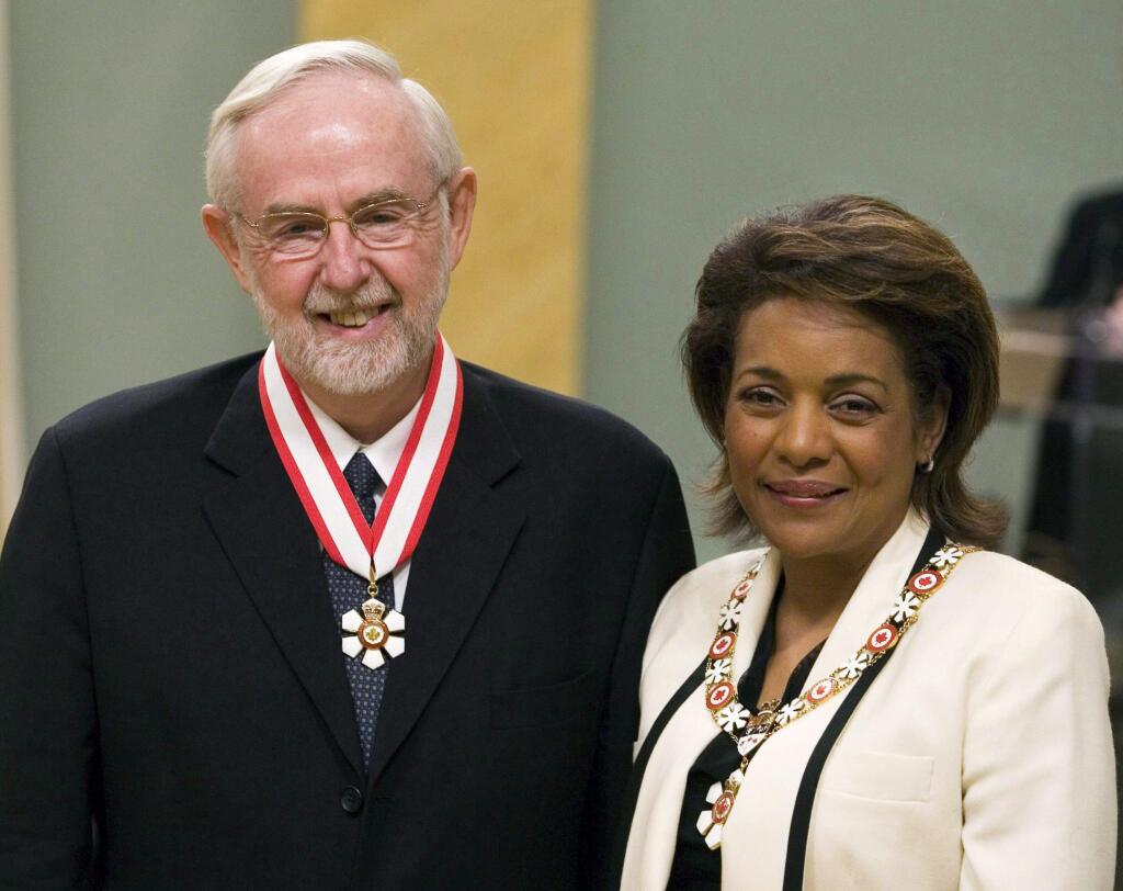 In this April 11, 2008, photo, scientist Arthur McDonald, left, of Kingston, Ontario, is invested as Officer to the Order of Canada by Governor General Michaelle Jean during a ceremony at Rideau Hall in Ottawa, Ontario. McDonald, a professor emeritus at Queen's University in Kingston, Ontario, and the director of the Sudbury Neutrino Observatory in northern Ontario, is a co-winner of this year's 2015 Nobel Prize for Physics. McDonald, and Japanese scientist Takaaki Kajita, were cited for the discovery of neutrino oscillations and their contributions to experiments showing that neutrinos change identities. (Fred Chartrand/The Canadian Press via AP) MANDATORY CREDIT
