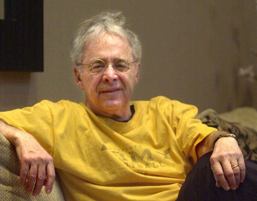 FILE - In this Dec. 20, 2002 file photo, Chuck Barris, the man behind TV's 'The Dating Game,' poses in the lobby of his apartment in New York. Game show impresario Barris has died at 87. Barris, the madcap producer of 'The Gong Show' and 'The Dating Game,' died of natural causes Tuesday afternoon, March 21, 2017, at his home in Palisades, New York. (AP Photo/Bebeto Matthews, File)