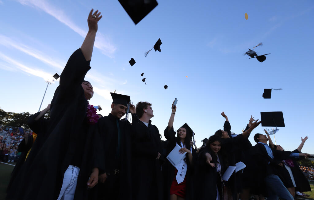 Students celebrate by throwing their caps at the close of their graduation ceremony at Sonoma Valley High School, Friday, June 10, 2022, in Sonoma. (Darryl Bush / For The Press Democrat)