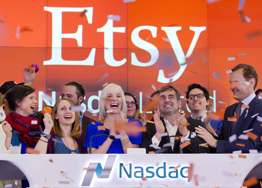 Kristina Salen, center left, Etsys Chief Financial Officer, stands with Chad Dickerson, center right, Chairman and Chief Executive Officer of Etsy, to celebrate the company's IPO with employees and guests at the Nasdaq MarketSite, Thursday, April 16, 2015, in New York. (AP Photo/Mark Lennihan)