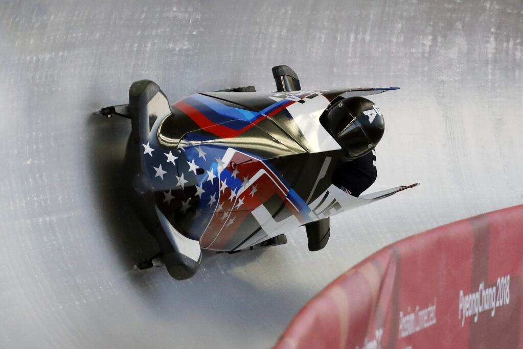 Driver Justin Olsen and Evan Weinstock of the United States take a curve during the two-man bobsled training at the 2018 Winter Olympics in Pyeongchang, South Korea, Friday, Feb. 16, 2018. (AP Photo/Andy Wong)