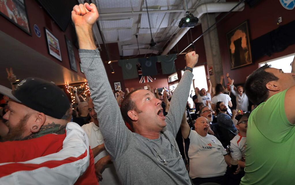 Peter Colbert of Santa Rosa celebrates England's first goal in their semi-final soccer match with Croatia during World Cup soccer, Wednesday July 11, 2018 at the English pub Toad in the Hole in Santa Rosa. (Kent Porter / The Press Democrat) 2018