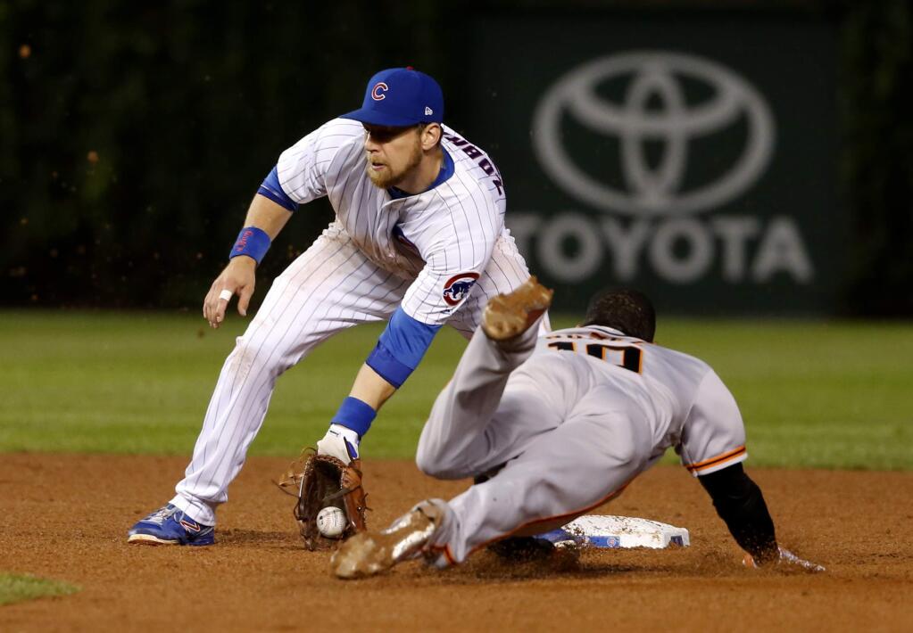 Chicago Cubs' Ben Zobrist, left, takes a throw from catcher Willson Contreras and tags San Francisco Giants' Eduardo Nunez out at second during the fifth inning Tuesday, May 23, 2017, in Chicago. (AP Photo/Charles Rex Arbogast)