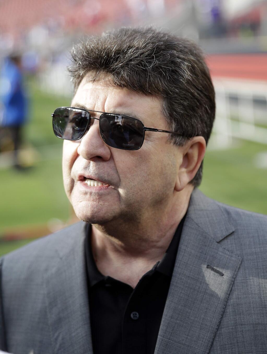 Former San Francisco 49ers owner Eddie DeBartolo Jr., right, speaks to reporters before an NFL football game between the San Francisco 49ers and the Minnesota Vikings in Santa Clara, Calif., Monday, Sept. 14, 2015. (AP Photo/Marcio Jose Sanchez)