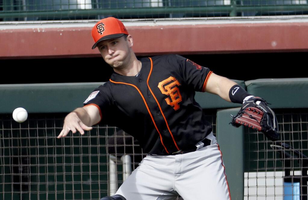 In this Feb. 15, 2019, file photo, San Francisco Giants catcher Buster Posey works out during a spring training practice in Scottsdale, Ariz. (AP Photo/Matt York, File)