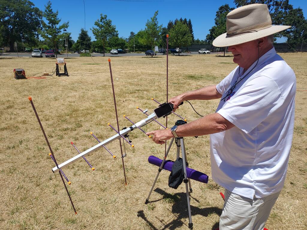 Amateur radio operator Bob Matreci uses a handheld satellite to communicate with other operators during an event at Finley Community Park on Saturday, June 25, 2022. (Paulina Pineda / The Press Democrat)