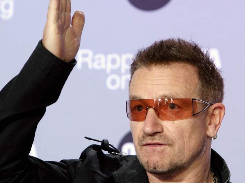 FILE - In this June 18, 2008 file photo, U2 lead singer and activist Bono presents 'The Data Report 2008', during a news conference, in Paris. Bono, Matt Damon, Ben Affleck and Morgan Freeman are among the celebrities who are playing the waiting the game in a new online campaign calling for a unified response from the world's leaders to the Ebola epidemic in West Africa. In a video posted Wednesday, Nov. 19, 2014, stars such as Will Ferrell, Thandie Newton and Connie Britton stare silently into a camera to illustrate that they're still waiting for the world's leaders to act on fighting Ebola, which has killed more than 5,000 people in the west African countries of Sierra Leone, Guinea and Liberia. (AP Photo/Jacques Brinon, File)