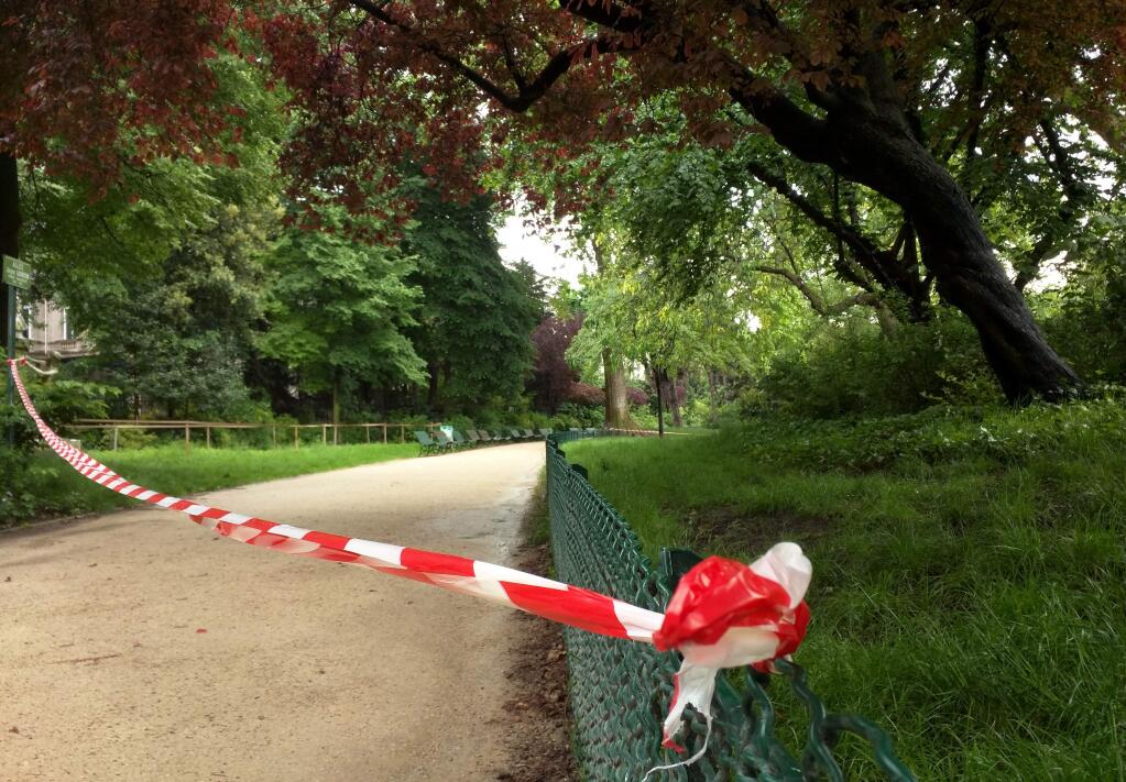 White-and-red tape is strung across a sandy pathway through Park Monceau after a lightning stike, in Paris, Saturday, May 28, 2016. A Paris fire service spokesman says 11 people including eight children have been hit by lightning in a Paris park after a sudden spring storm overtook a child's birthday party. The victims had sought shelter Saturday under a tree at Park Monceau, a popular weekend hangout for well-to-do families in Paris. (AP Photo/Raphael Satter)