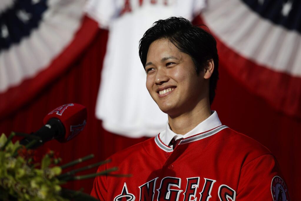 Baseball player Shohei Ohtani, from Japan, smiles during a news conference at Angel Stadium, Saturday, Dec. 9, 2017, in Anaheim. Ohtani, who intends to be both a starting pitcher and an everyday power hitter, turned down interest from every other big-league club to join two-time MVP Mike Trout and slugger Albert Pujols with the Angels, who are coming off their second consecutive losing season and haven't won a playoff game since 2009. (AP Photo/Jae C. Hong)