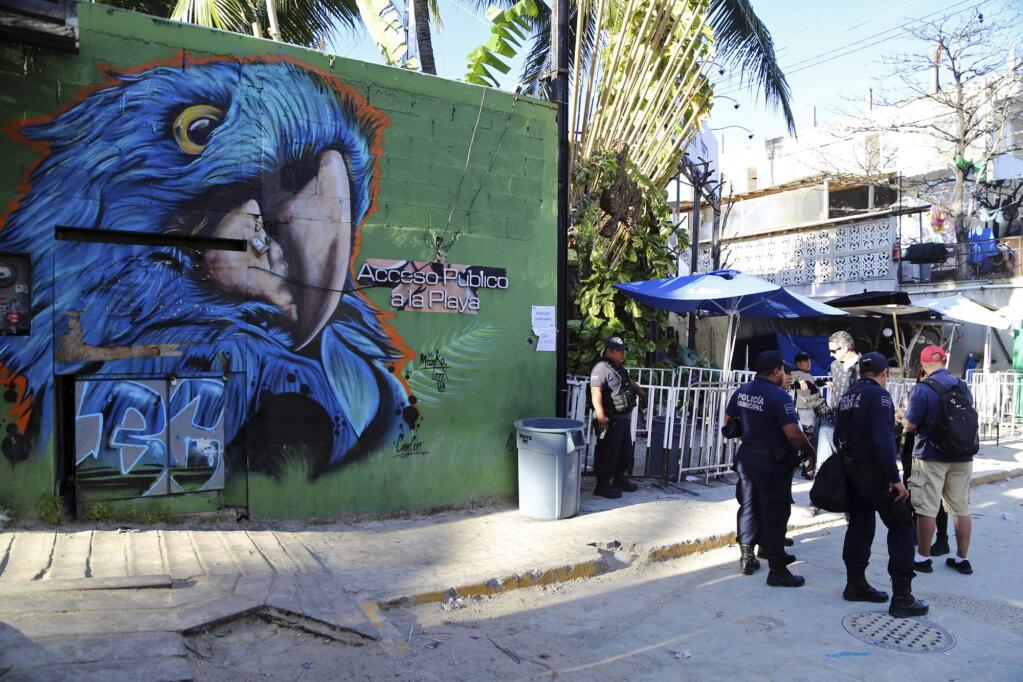 Police guard the entrance of the Blue Parrot nightclub in Playa del Carmen, Mexico, Monday, Jan. 16, 2017. A deadly shooting occurred in the early morning hours outside the nightclub while it was hosting part of the BPM electronic music festival, according to police. (AP Photo)