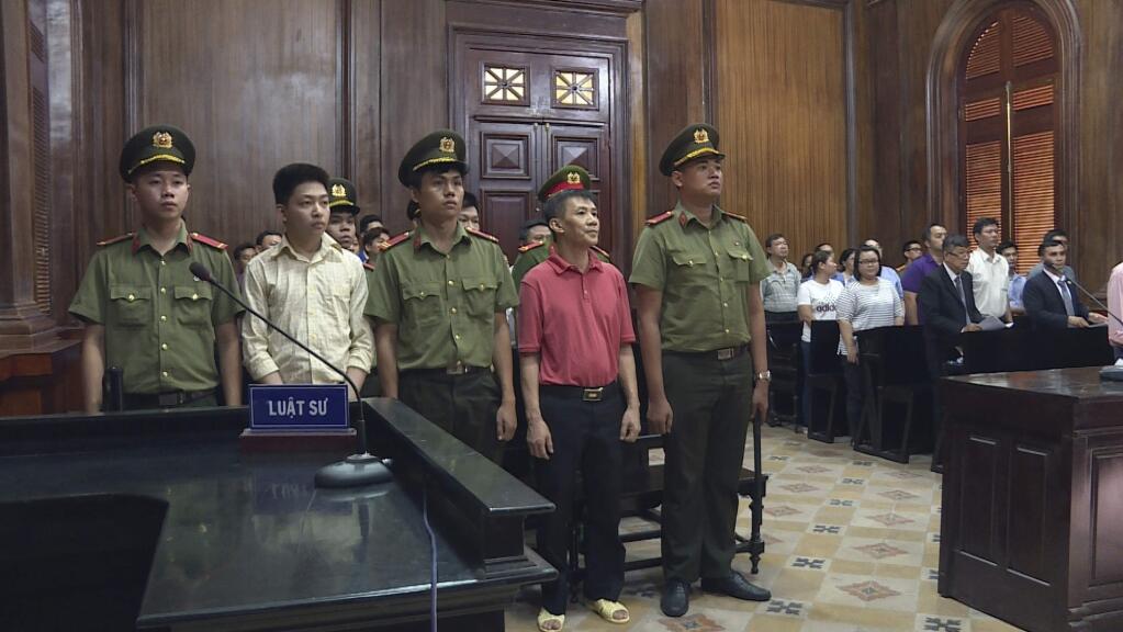 Michael Nguyen stands during his trial, Monday, June, 24, 2019, in Ho Chin Minh City, Vietnam. The American of Vietnamese origin was sentenced to 12 years in prison for 'attempt to overthrow the state.' (Nguyen Thanh Chung/Vietnam News Agency via AP)