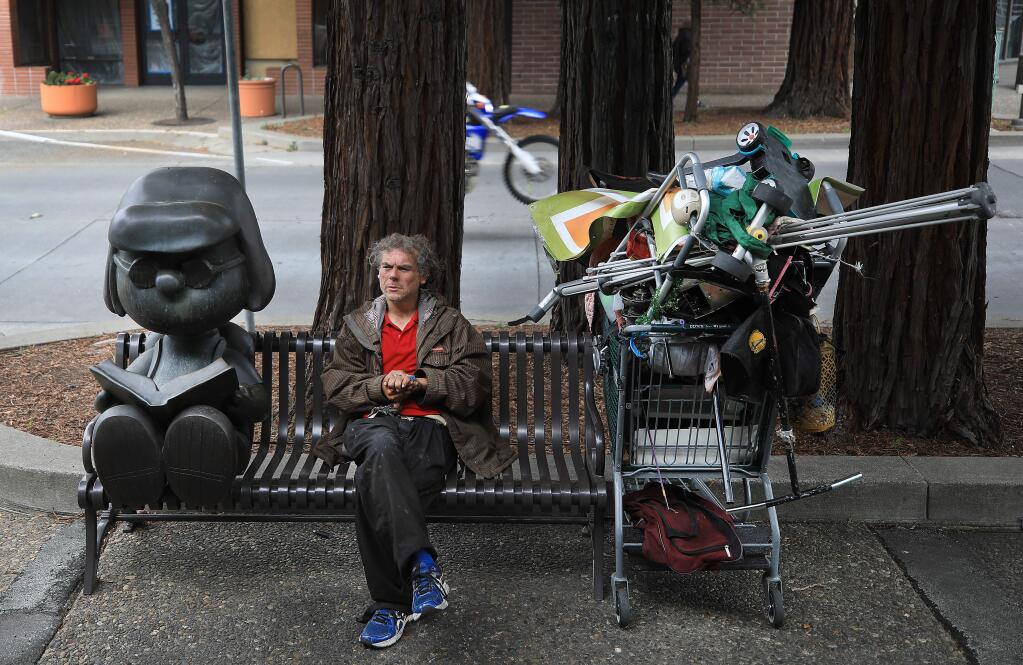 Edward Montez, who grew up in Santa Rosa, passes the time by social distancing on Fourth Street in Santa Rosa, as he attempts figure out a place to set up camp for the night, Saturday, April 18, 2020. (Kent Porter / The Press Democrat) 2020