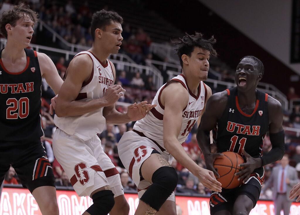 Utah's Both Gach, right, drives the ball against Stanford's Spencer Jones (14) in the second half Wednesday, Feb. 26, 2020, in Stanford. (AP Photo/Ben Margot)