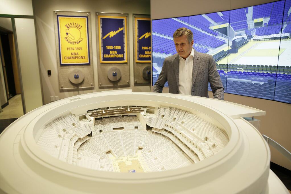 In this Jan. 24, 2018, file photo, Golden State Warriors president and COO Rick Welts looks over a model of Chase Center at the Chase Center Experience in San Francisco. (AP Photo/Eric Risberg, File)