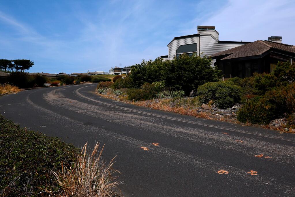 Evidence markers, at lower right, remain visible on Pelican Loop after an officer-involved shooting in Bodega Bay, California, on Saturday, July 6, 2019. Two days earlier, on July 4, a San Francisco man under the influence of drugs injured several people in the Bodega Bay neighborhood before being shot by a Sonoma County sheriff's deputy. (Alvin Jornada / The Press Democrat)