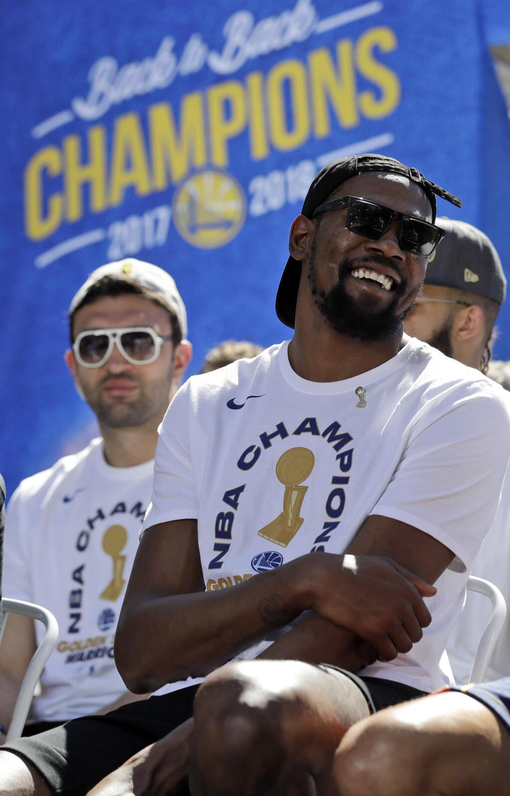 Golden State Warriors' Kevin Durant smiles before the start of the team's NBA championship parade, Tuesday, June 12, 2018, in Oakland, Calif. (AP Photo/Marcio Jose Sanchez)