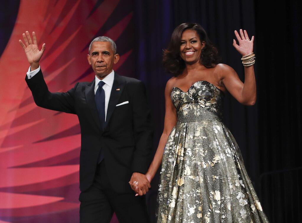 FILE - This Sept. 17, 2016 file photo shows President Barack Obama and first lady Michelle Obama at the Congressional Black Caucus Foundation's 46th Annual Legislative Conference Phoenix Awards Dinner in Washington. The former president and first lady have signed with Penguin Random House, the publisher announced Tuesday, Feb. 28, 2017. (AP Photo/Pablo Martinez Monsivais, File)