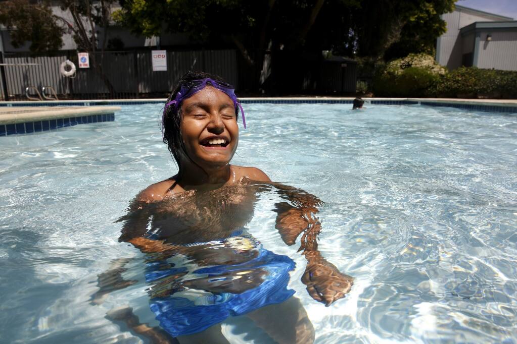 Aaron Valdovinos, 10, swims at his family's new apartment complex in Santa Rosa, on Sunday, August 2, 2015. Valdovinos, now 11, lived in an apartment on Hoen Avenue in Santa Rosa that was riddled with mold and asbestos, according to city inspection records. During the nine years he lived in the apartment, he had severe asthma flares and was routinely taken to the hospital, his doctors said. The boy's health improved when the family moved last year. He is now able to play outside and has only been to the doctor once over the past 11 months for a checkup, said his mother, Juana Paniagua. (BETH SCHLANKER/ The Press Democrat)