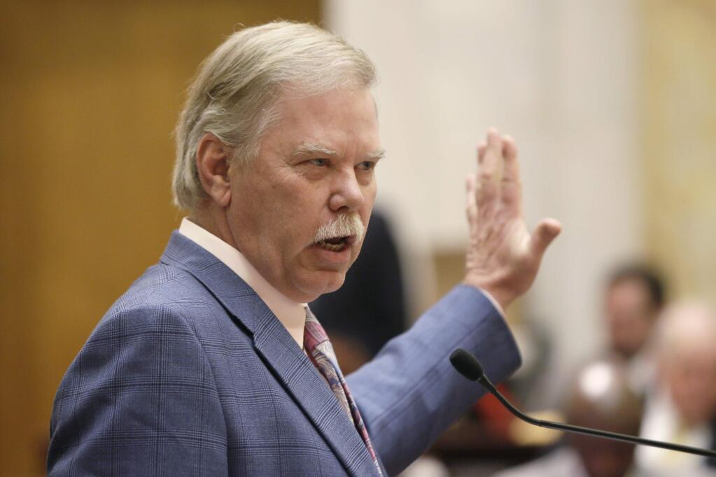 Rep. Dan M. Douglas, R-Bentonville, explains his bill dealing with alternative fuels tax in the House chamber at the Arkansas state Capitol in Little Rock, Ark., Friday, March 20, 2015. (AP Photo/Danny Johnston)
