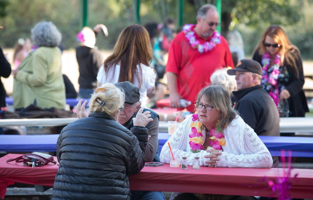 Guests visit with each other during the annual Hawaiian Luau benefitting the Penngrove Social Firemen in Penngrove, Calif. Saturday September 10, 2016. (Jeremy Portje / For The Press Democrat)