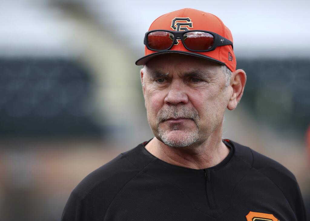 In this Feb. 19, 2018 file photo, San Francisco Giants manager Bruce Bochy oversees a spring training baseball practice in Scottsdale, Ariz. 'You talk to the players and you can see a different attitude coming into this spring with what's happened this offseason,' manager Bruce Bochy said. 'And also the fact that it's a new slate and we're going to be healthy, so there's a lot of reason to be optimistic.' (AP Photo/Ben Margot, File)