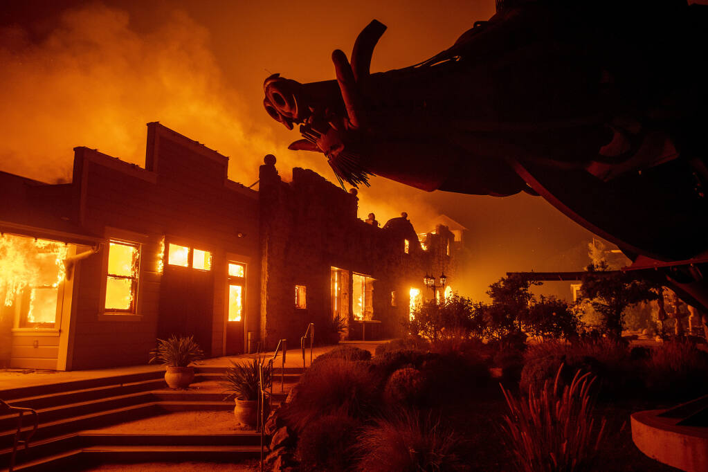 In this Oct. 27, 2019, file photo, flames from the Kincade Fire consume Soda Rock Winery in Healdsburg, Calif. A California prosecutor has charged troubled Pacific Gas & Electric with starting a 2019 wildfire. District Judge William Alsup overseeing Pacific Gas & Electric's criminal probation is holding a hearing Tuesday, May 4, 2021, to consider whether Pacific Gas & Electric violated its criminal probation from a fatal 2010 natural gas explosion by sparking the October 2019 Kincade Fire north of San Francisco. (AP Photo/Noah Berger, File)