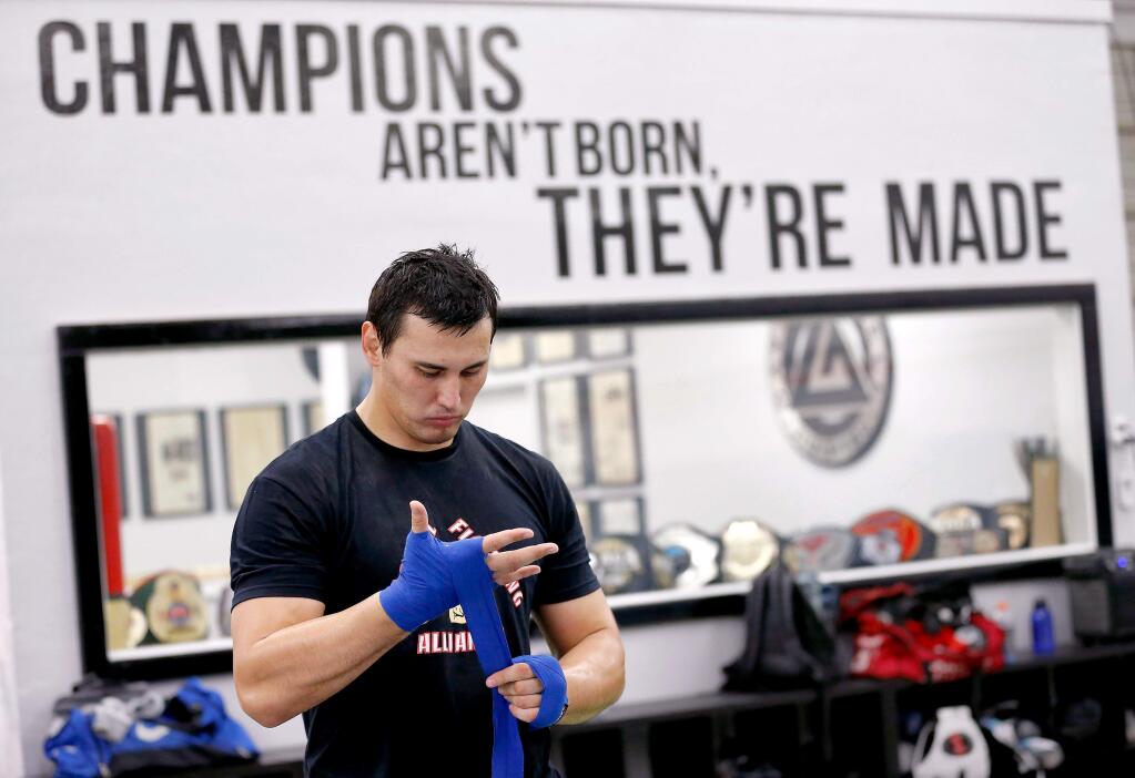 Kyrgystani professional freestyle wrestler Aiaal Lazarev, who is now training to become a mixed martial arts fighter, wraps his hands for a boxing workout at NorCal Fighting Alliance in Santa Rosa, California, on Thursday, April 11, 2019. (Alvin Jornada / The Press Democrat)