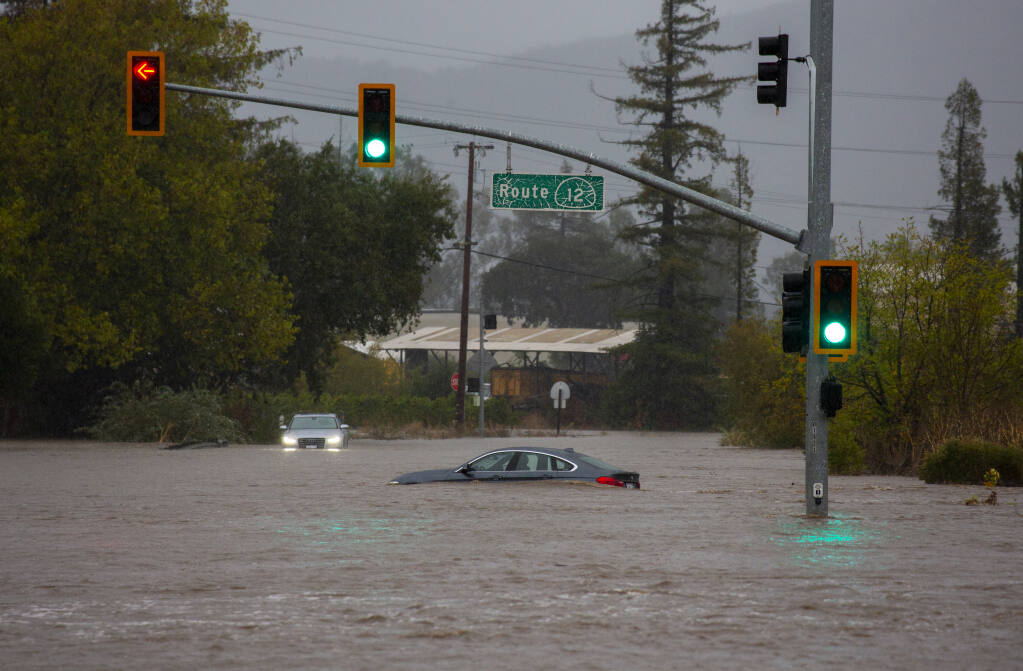 Two cars were stranded in the floodwaters at the intersection of Highway 121 and Highway 12. The bomb cyclone that pelted Sonoma Valley on Sunday, Oct. 24, 2021, flooded roads, stranded cars and closed businesses for the day. (Photo by Robbi Pengelly/Index-Tribune)