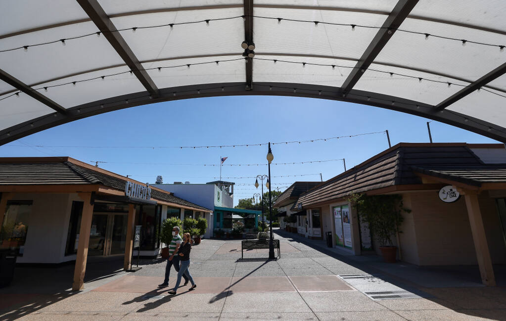 Shoppers walk through a courtyard at Montgomery Village in Santa Rosa on Tuesday, June 8, 2021.  (Christopher Chung/ The Press Democrat)