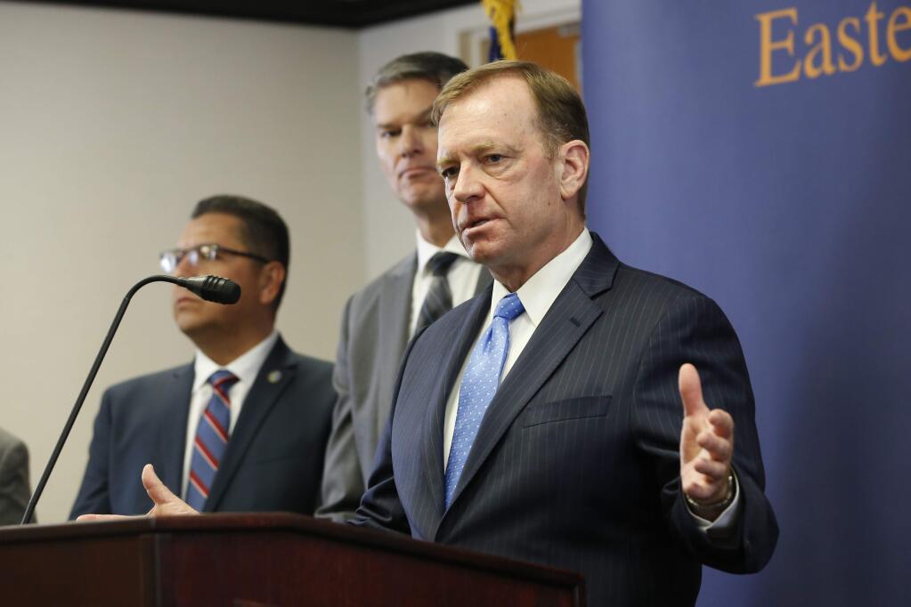 FILE - In this June 6, 2019, file photo, McGregor Scott, the United States Attorney for the Eastern District of California, answers questions concerning the charges against leaders of the white supremacist prison gang, the Aryan Brotherhood, during a news conference in Sacramento. Two weeks after authorities accused purported leaders of a white supremacist gang with organizing drug trafficking and murders from their California prison cells, they're charging leaders of another prison gang with running a crime ring from behind bars. U.S. Attorney Scott and California Attorney General Xavier Becerra announced Wednesday, June 19, 2019, that authorities arrested 54 people on allegations that they are connected to the Nuestra Familia prison gang and affiliated Norteno street gang. (AP Photo/Rich Pedroncelli, File)
