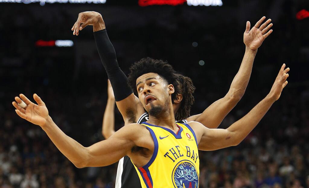 Golden State Warriors guard Quinn Cookwatches a 3-pointer by San Antonio Spurs guard Patty Mills during the second half Monday, March 19, 2018, in San Antonio. San Antonio won 89-75. (AP Photo/Ronald Cortes)