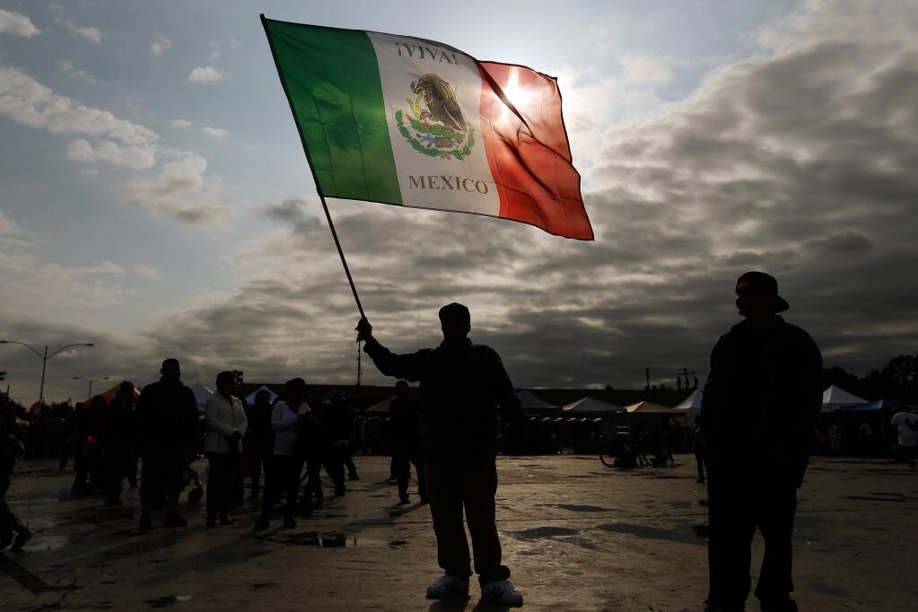 Jesus Arango proudly waves his Mexican flag during the Roseland Cinco de Mayo celebration in Santa Rosa, California, on Thursday, May 5, 2016. (Alvin Jornada / The Press Democrat)