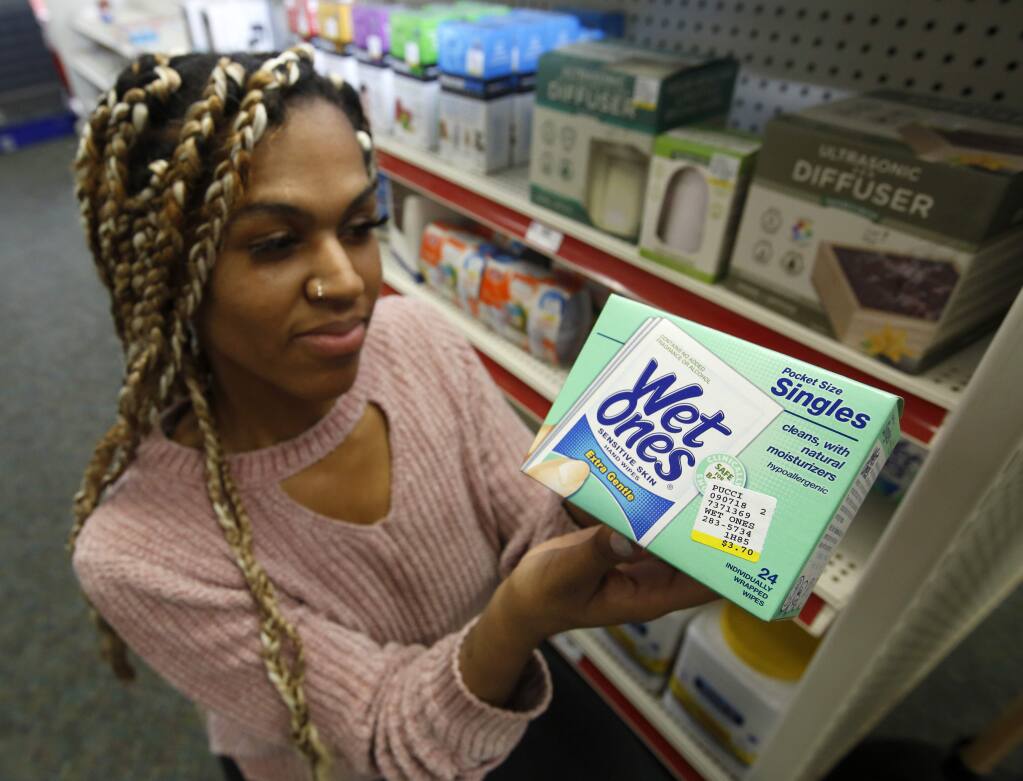 Alice White displays a package of disposal single use wipes at Pucci's Leader Pharmacy in Sacramento, Calif., Thursday, Jan. 23, 2020. A proposal by Assemblyman Richard Bloom, D-Santa Monica, that would require products that cannot be flushed down the toilet to be clearly labeled as such was approved by the Assembly Appropriations Committee, Thursday, Jan. 23, 2020. It now goes for a vote in the Assembly. (AP Photo/Rich Pedroncelli)