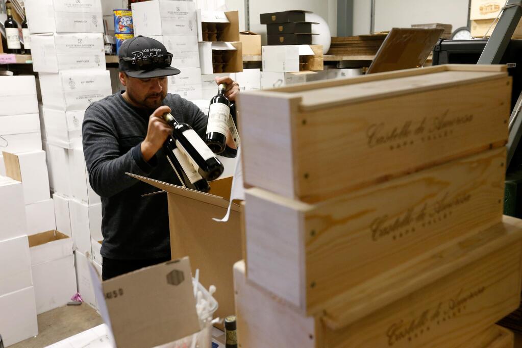 Shipping warehouse manager Francisco Campos packages bottles for shipment at Castello di Amorosa in Calistoga on Thursday, Dec. 1, 2016. (ALVIN JORNADA/ PD)