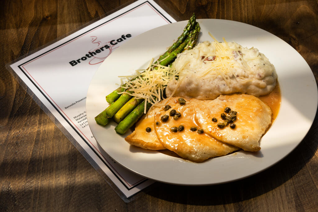 Chicken piccata with lemon juice, butter and capers, accompanied by mashed potatoes and grilled asparagus at the Brothers Cafe. Photo taken Thursday, April 27, 2023. (John Burgess / The Press Democrat)